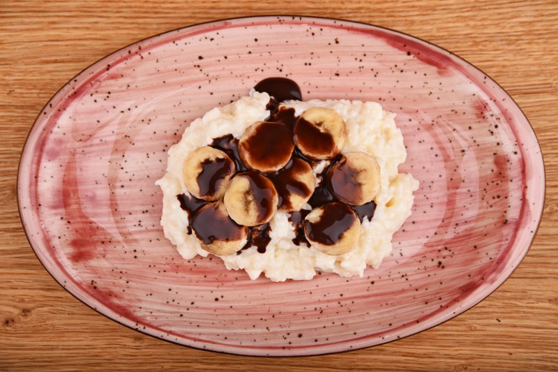 Rice pudding with chocolate sauce and banana