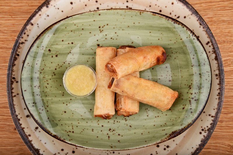 Spring rolls stuffed with vegetables and cheese, with ginger sauce